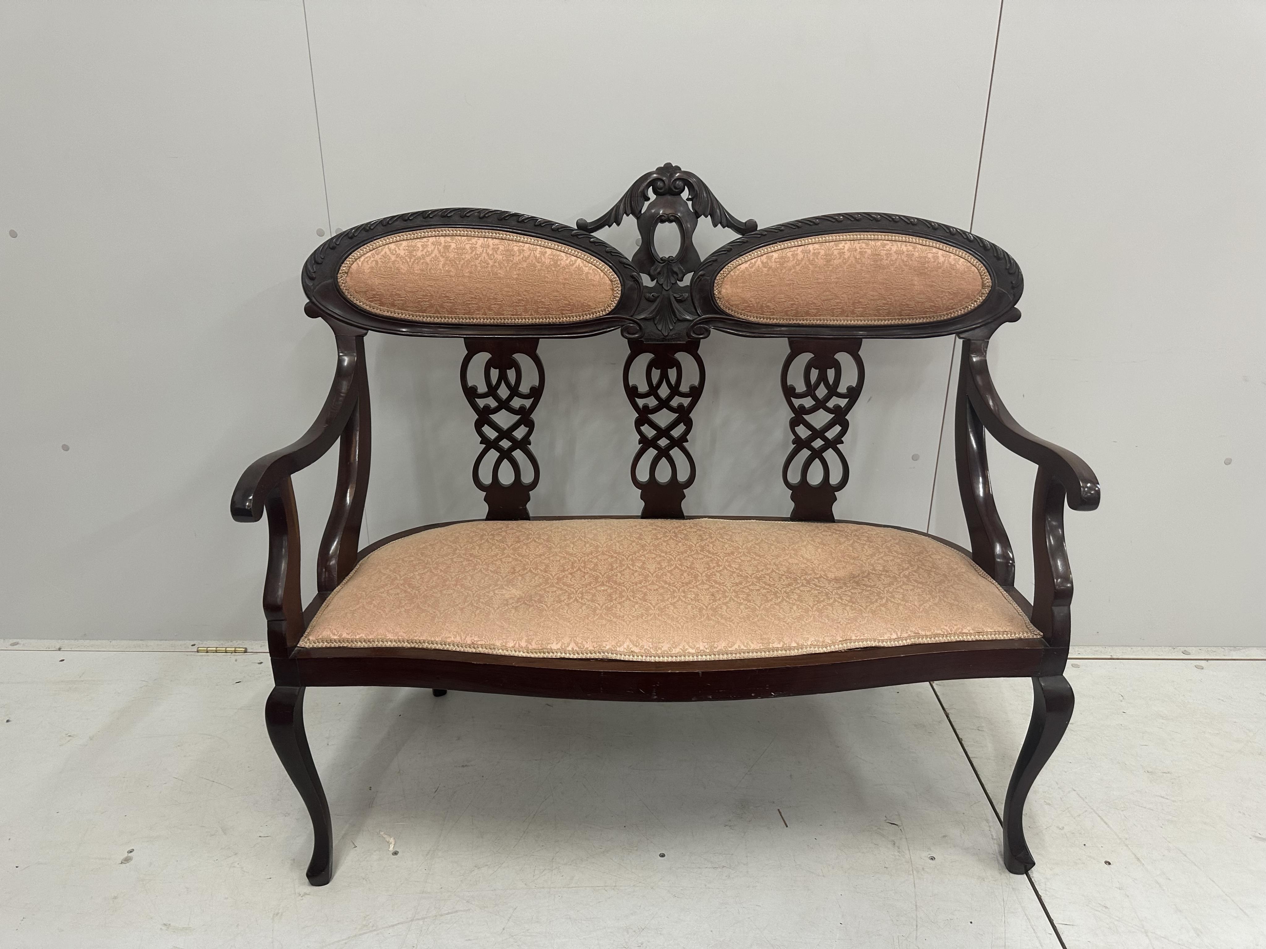 A late Victorian carved mahogany seven piece salon suite, settee width 120cm, depth 50cm, height 105cm. Condition - fair to good